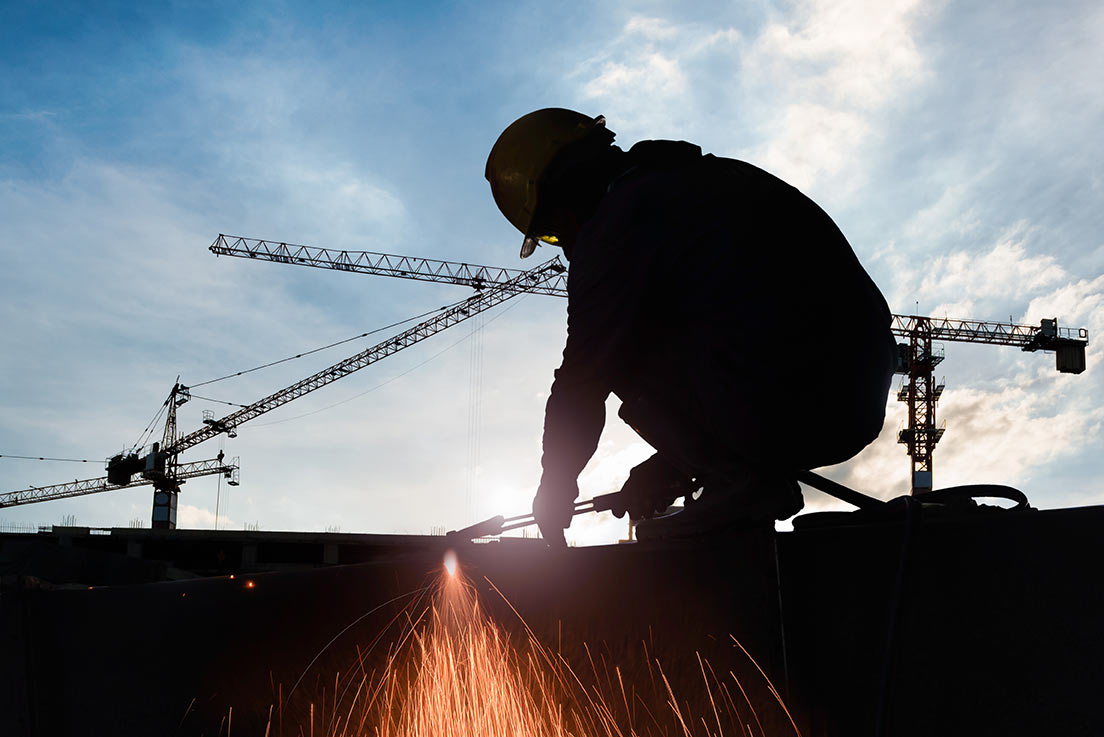 man welding in dangerous conditions